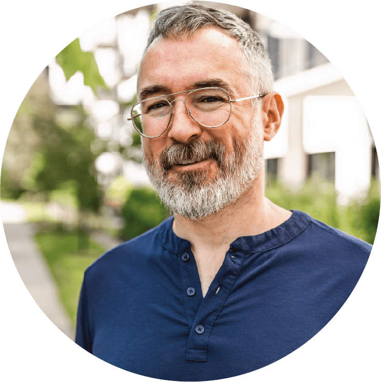 A man in his fifties with glasses, outdoors